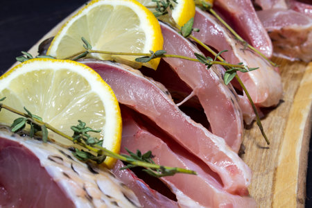 Step 3. Steak-cut carp with lemon and sprigs of thyme. Products for the preparation of baked carp....