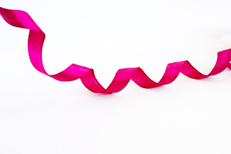 Silk ribbon. Decorative element isolated on a white background. Close-up.