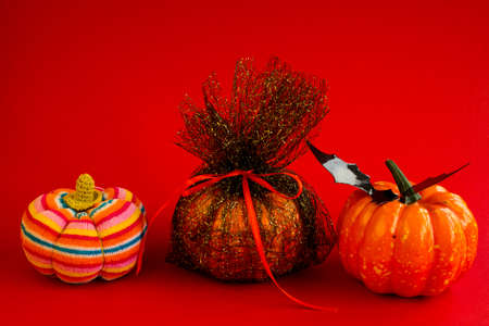 Halloween. Decorative pumpkins on a red background. Decorations for the celebration of halloween. Copy space for text.の写真素材