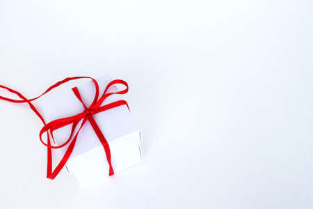 White box with red ribbon isolated on a white background. The concept of gifts for the holidays. Place for text. Top view.の写真素材