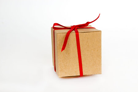 Gift box with red ribbon isolated on white. The concept of gifts for the holidays. Christmas and New...