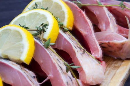 Step 2. Steak-cut carp with lemon and thyme sprigs. Products for the preparation of baked carp. Products for a traditional fish recipe. Close-up. Top view.の写真素材