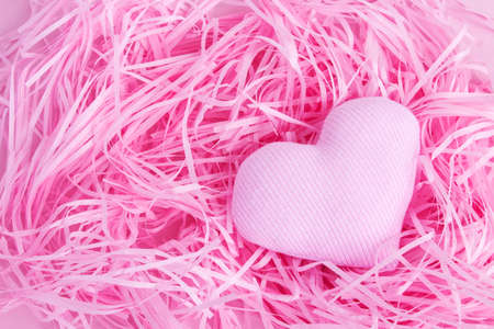 Gentle Valentine's Day background. Hearts on a pink background. Happy holiday greetings concept. Place for text. Flat layout.の写真素材