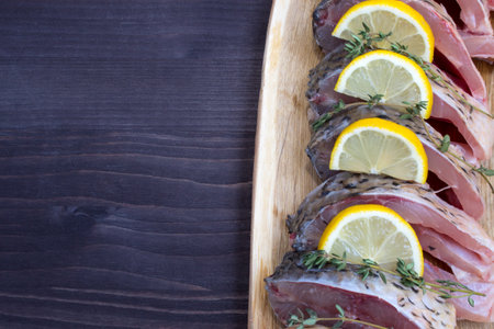 Step 2. Steaky carp with lemon and sprigs of thyme. Products for the preparation of baked carp. Products for a traditional fish recipe. Flat layout. View from above. Copy space.の写真素材