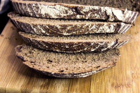 Traditional rye bread. Sliced â€‹â€‹rye bread on a cutting board. Bread slices. Close-up.