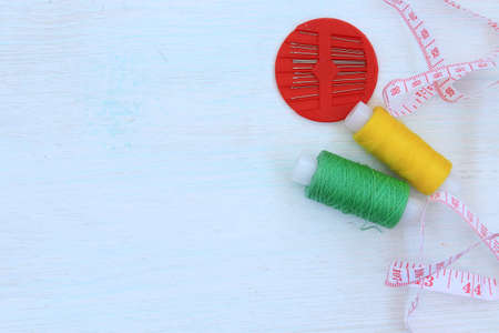 Needlework. Threads, sewing needles, tape measure. Materials for creative work on a light background. Female hobb concept. Everything for creativity. Copy space.の写真素材