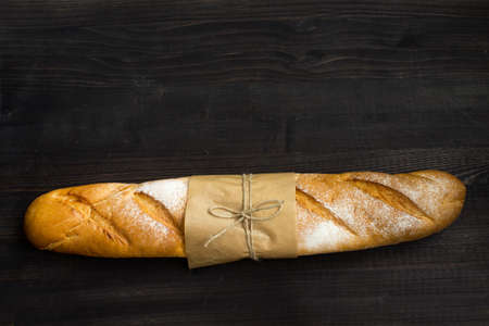Baguette. Fresh golden baguette on an old wooden table. French traditional bread. Top view. Copy space.の写真素材