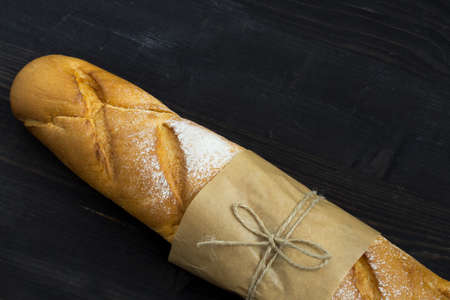 Baguette. Fresh golden baguette on an old wooden table. French traditional bread. Top view. Copy space.の写真素材
