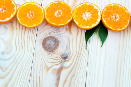 Summer background with orange slices. Orange slices on a light wooden background. Juicy and colorful...