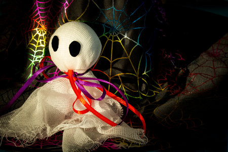 Halloween. Ghost figure on a colorful background. Decorative decorations for halloween. Copy space. Halloween home decoration concept.の写真素材