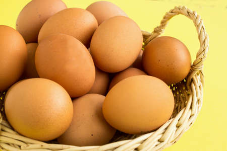 Fresh chicken eggs in a basket. Products from local farmers. Healthy eating. The concept of consumption of products of local producers.の写真素材