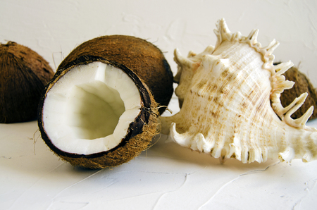 Pieces of coconut on white background, flat lay, top view. Vegetarian table. Close-up.の写真素材