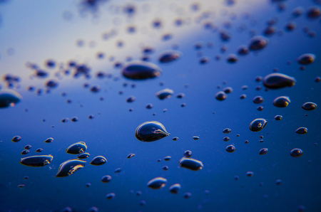 Raindrops or water droplets on the surface of the car. Hydrophobic property after the application of nano-ceramics. Abstract background and water texture for design.の写真素材