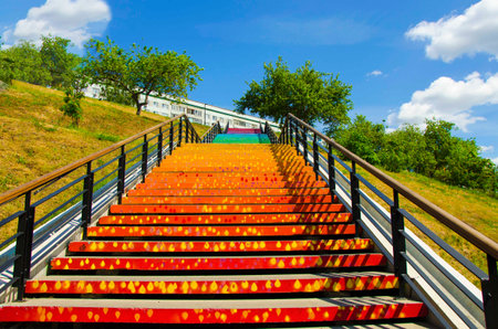 Staircase with colorful steps, in the form of a rainbow. Creative staircase on the city embankment....