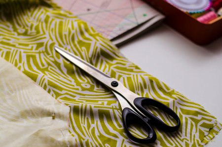 Tools and accessories for tailoring. Sewing kit: scissors, sewing thread, needles, pattern dress...