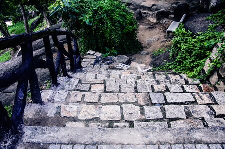 Old stone stairs in the park with wooden railing. Outdoors stone steps. Pilgrimage to the ancient shrines.の写真素材