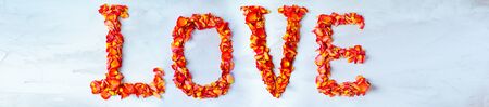 The inscription LOVE of rose petals. Copy space.の写真素材