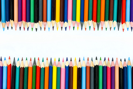 colored pencils lined up on a white backgroundの写真素材