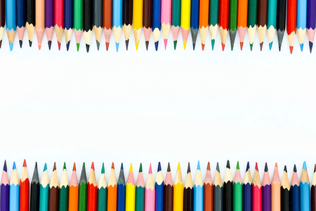 colored pencils lined up on a white backgroundの写真素材