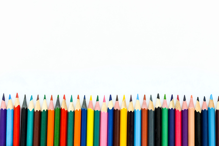 colored pencils lined up on a white backgroundの写真素材