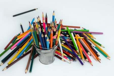 colored pencils lined up on a white backgroundの写真素材