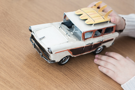 game with a retro car with yellow surfboards on the trunkの写真素材