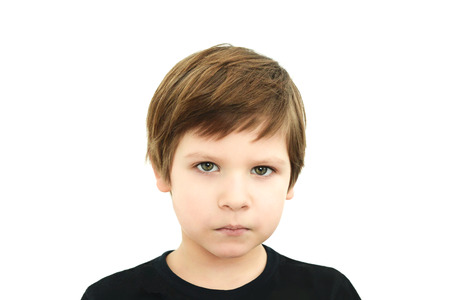 sad boy in black t-shirt on white background, sadness, european typeの写真素材