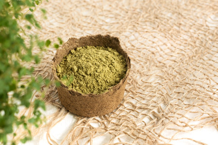 henna powder for dyeing hair and eyebrows and drawing mehendi on hands,  with green  leafs, pink...