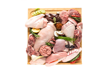 Different types of turkey meat and chicken, steaks, carcass poultry for cooking, top view on a wooden board, isolate on a white background. Flat lay, cooking conceptの写真素材