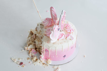 Crash pink cake at the celebration of the first birthday of the girl, ruined sponge cake, broken...
