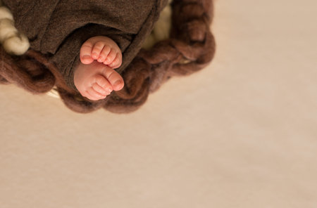 feet of the newborn baby, fingers on the foot, maternal care, love and family hugs, tenderness