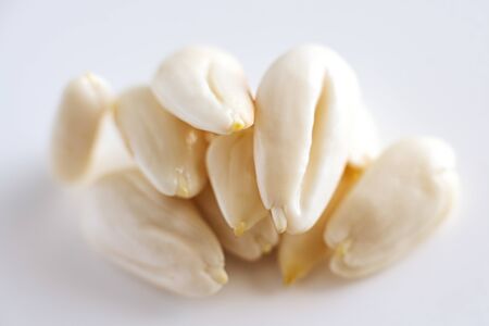peeled young almonds on a white background, isolate, nut antioxidant.の写真素材