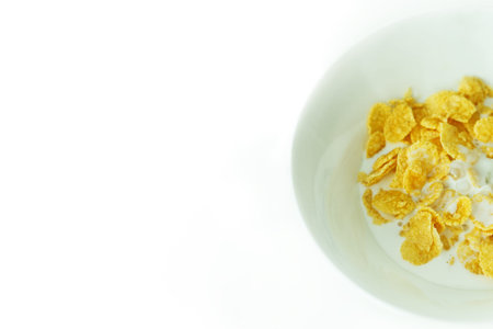 cereal with milk in a white plate for breakfast, space for text, isolate.