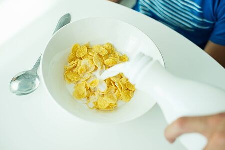 cereal with milk in a white plate for breakfast, space for text, isolateの写真素材