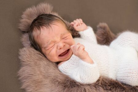 crying newborn baby, baby's tears, colic and impaired child health.の写真素材