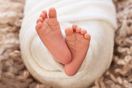  foot of the newborn baby, peeling skin, fingers, maternal care, love and family hugs, tenderness.