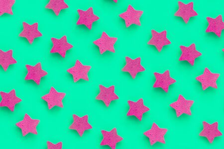 Pink stars on green background, place for text. pink cookies. Copy space. Mock upの写真素材