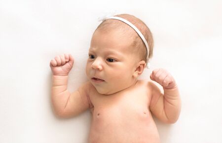 Newborn baby on white background, vintage style, top view.のeditorial素材