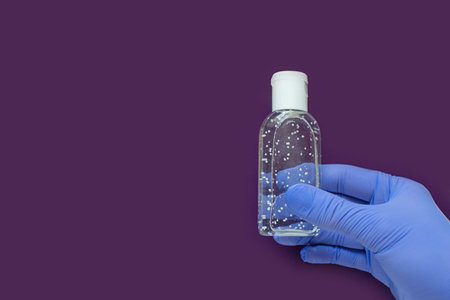 Hand in latex green medical protection gloves white sanitizer. Coronavirus optimistic hygiene...
