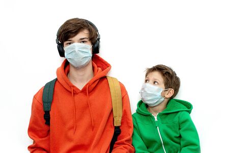 children in medical masks in bright clothes, isolated, copy space. Coronavirus protection.の写真素材