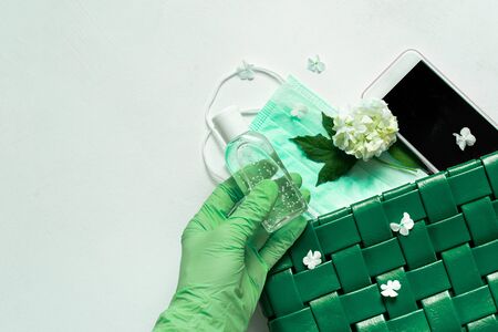 blue leather women bag with a medical mask, a sanitizer and gloves. Concept spring-summer 2020 exit from the coronavirus pandemic. protective equipment after isolationの写真素材