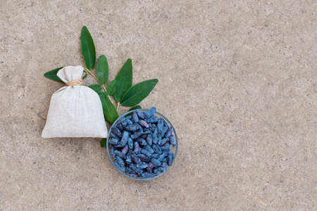honeysuckle berries on a concrete background. Summer blu berries. Green backgroundの写真素材
