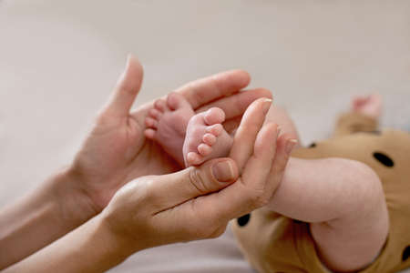 Newborn baby feet. Motherhood Mother day concept. Selective focus.の写真素材
