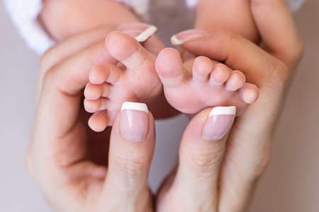 Newborn baby feet. Motherhood concept. Mother day. Copy space. Newborn baby feet. Motherhood concept. Mother day. Copy space. Selective focusの写真素材