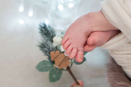 Newborn baby feet with Christmas decorations. new year 2021 tree concept.の写真素材
