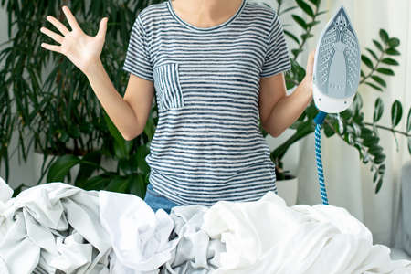 ironing of clothes. Homework. responsibilities for maintaining the house. Steam steamerの写真素材