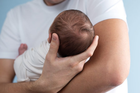 Dad is holding a newborn baby in his arms. Paternity. High quality photo. father and son