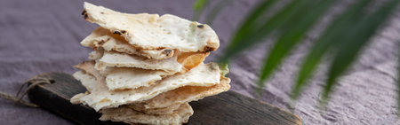 Homemade matzo with microgreen peas. Unleavened flatbread bread. Pesah celebration concept. Jewish...