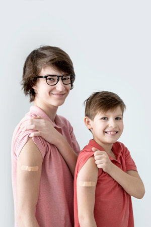 Vertical. Young men, teenager and boy vaccinated against infection.