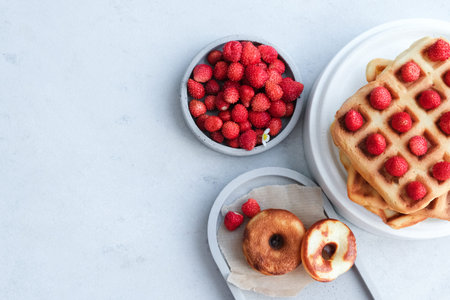 Belgian or Viennese waffles with strawberries on minimalistic concrete gray background. delicious...